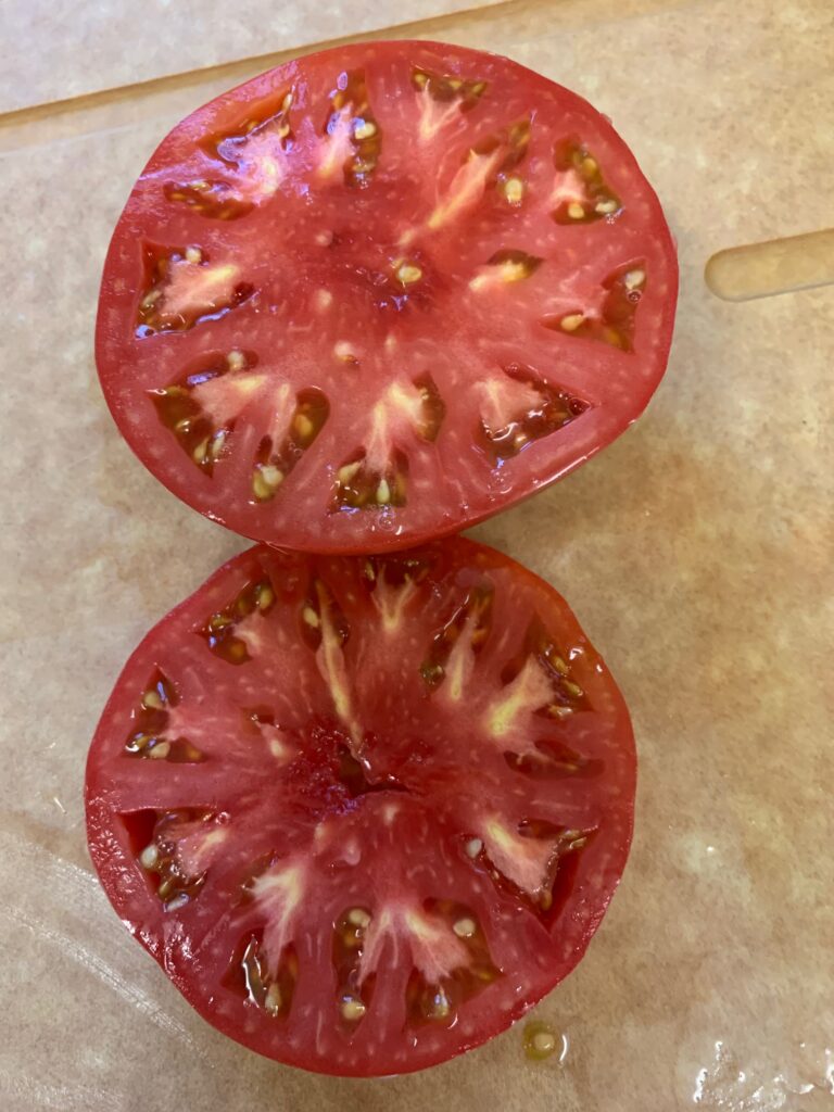 https://contrarymarysplants.com/wp-content/uploads/2021/01/Tomato-Aunt-Ginnys-Purple-sliced-my-pic-768x1024.jpg